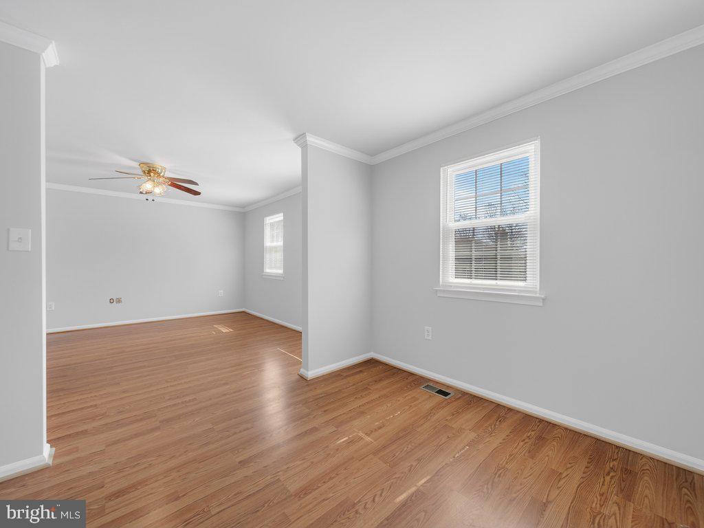3827 Gawayne Terrace Silver Spring, MD 20906 - Photo 25 of 45 an empty room with wooden floor and windows