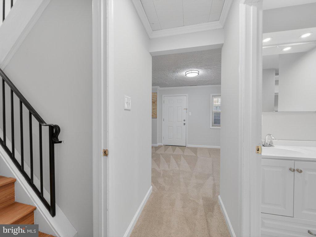 3827 Gawayne Terrace Silver Spring, MD 20906 - Photo 35 of 45 a view of a hallway with wooden floor and staircase