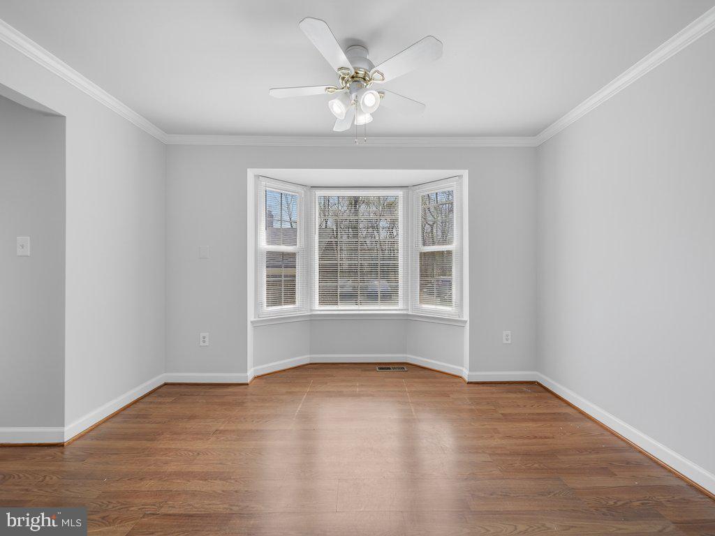 3827 Gawayne Terrace Silver Spring, MD 20906 - Photo 5 of 45 a view of an empty room with wooden floor and a window