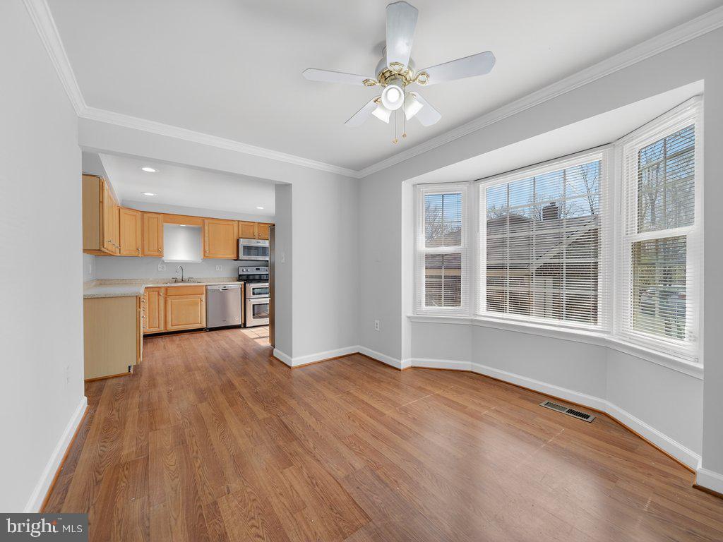 3827 Gawayne Terrace Silver Spring, MD 20906 - Photo 6 of 45 a view of an empty room with a window and wooden floor