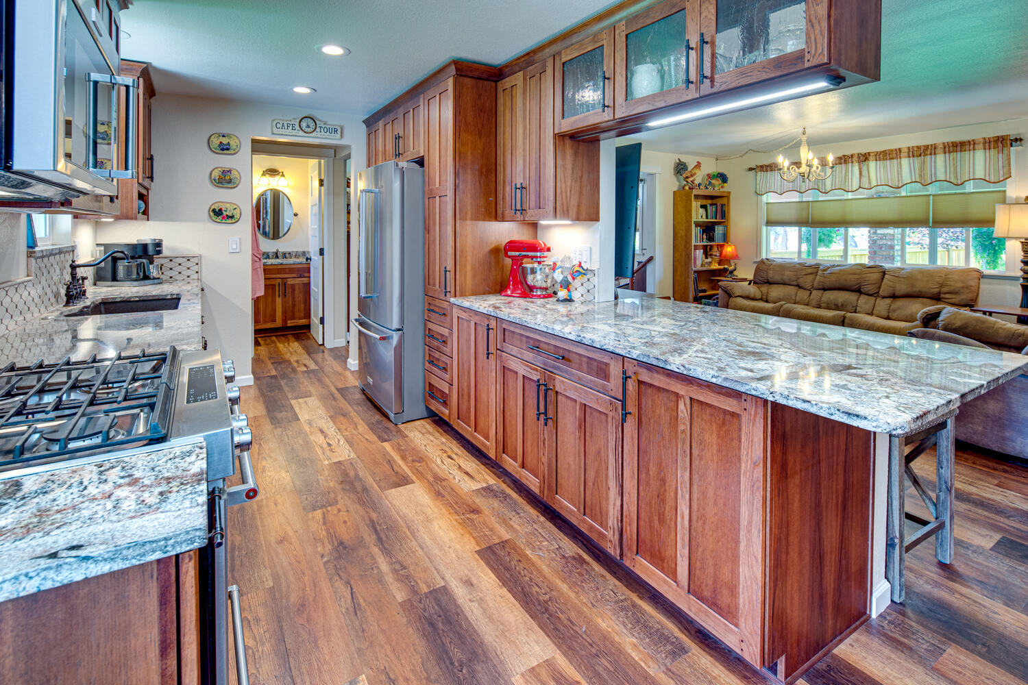 2218 Southwest 79th Street Redmond, OR 97756 - Photo 10 of 54 a kitchen with stainless steel appliances granite countertop a stove and a wooden cabinets