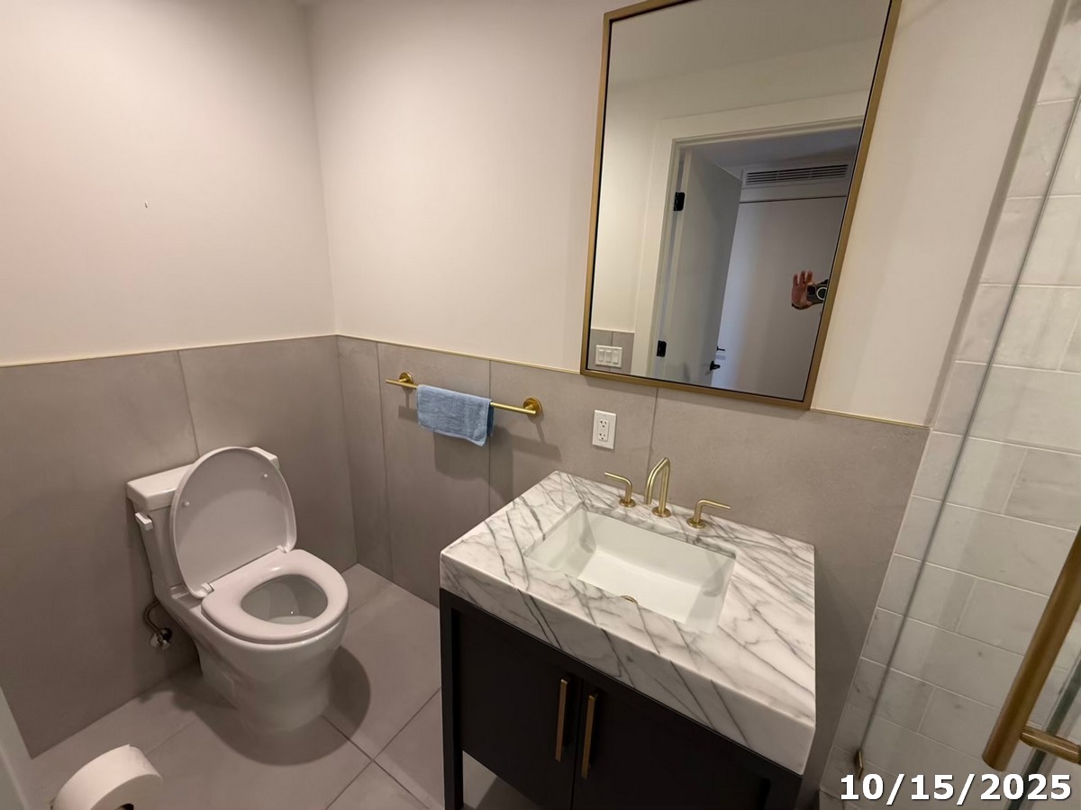 70 Rainey Street, Unit 2907 Austin, TX 78701 - Photo 12 of 15 a bathroom with a sink a toilet and a mirror