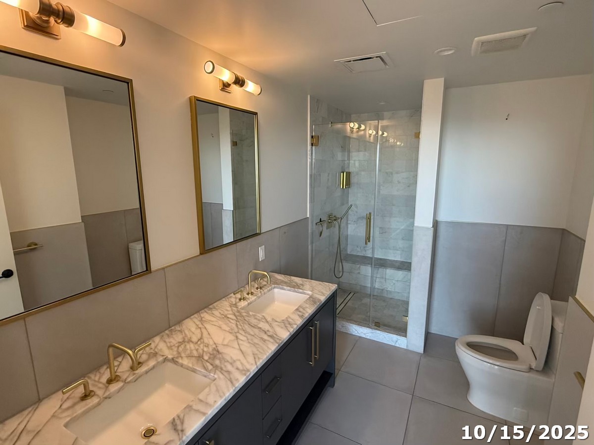 70 Rainey Street, Unit 2907 Austin, TX 78701 - Photo 10 of 15 a bathroom with a granite countertop sink a toilet and shower