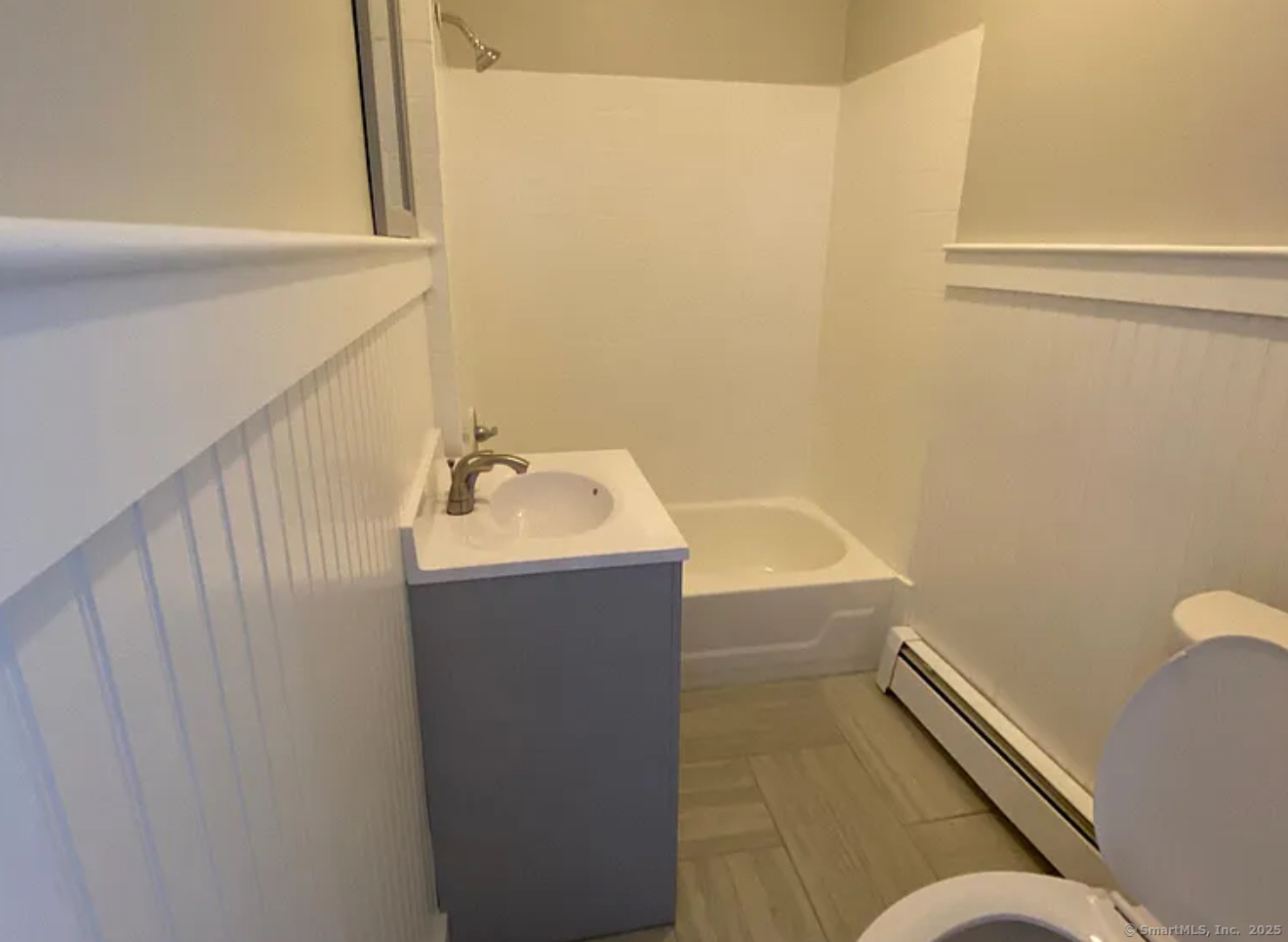 1389 Pembroke Street, Unit 1 Bridgeport, CT 06608 - Photo 2 of 3 a bathroom with a sink and a mirror