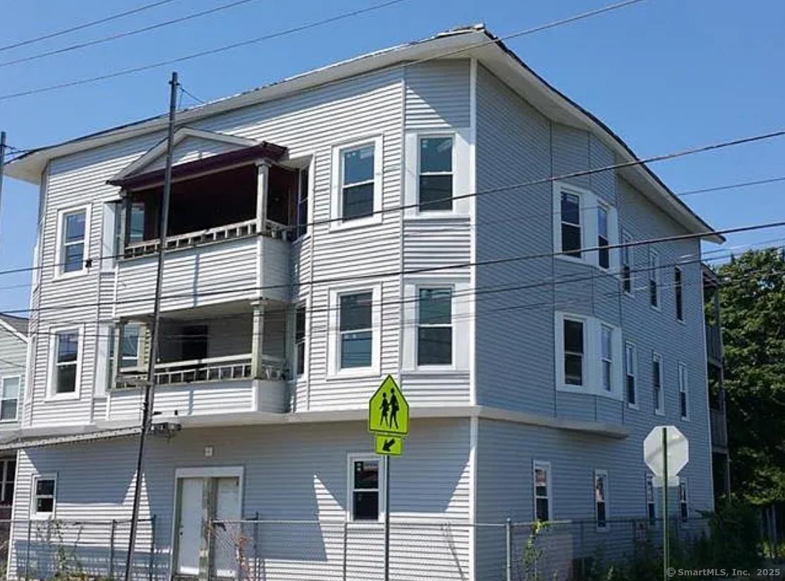 1389 Pembroke Street, Unit 1 Bridgeport, CT 06608 - Photo 3 of 3 a front view of a house with glass windows