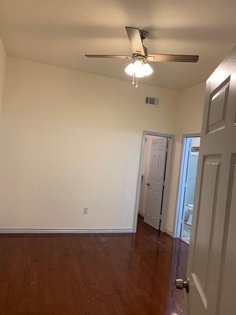 12046 Center Street, Unit 200 Quinlan, TX 75474 - Photo 6 of 9 en empty room with wooden floor and fan