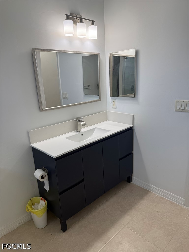 2916 7th Street Southwest Lehigh Acres, FL 33976 - Photo 14 of 19 a bathroom with a sink and a mirror