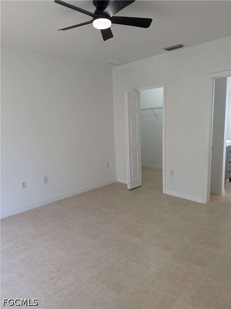 2916 7th Street Southwest Lehigh Acres, FL 33976 - Photo 15 of 19 an empty room with a ceiling fan and a window