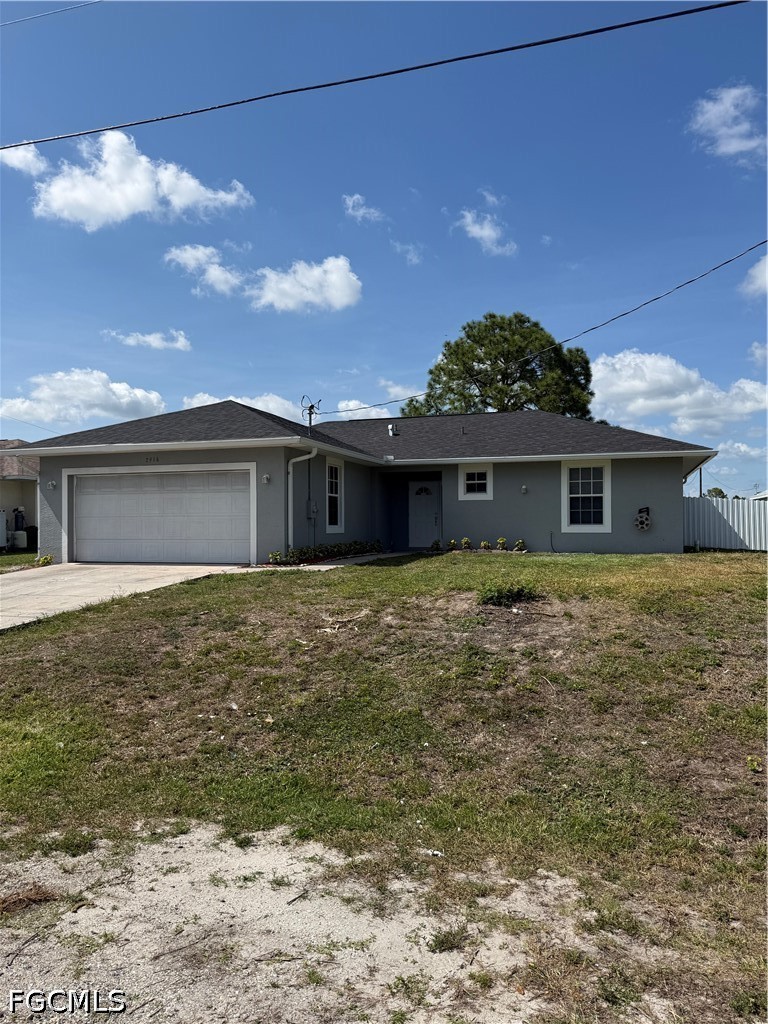 2916 7th Street Southwest Lehigh Acres, FL 33976 - Photo 2 of 19 front view of a house with a yard