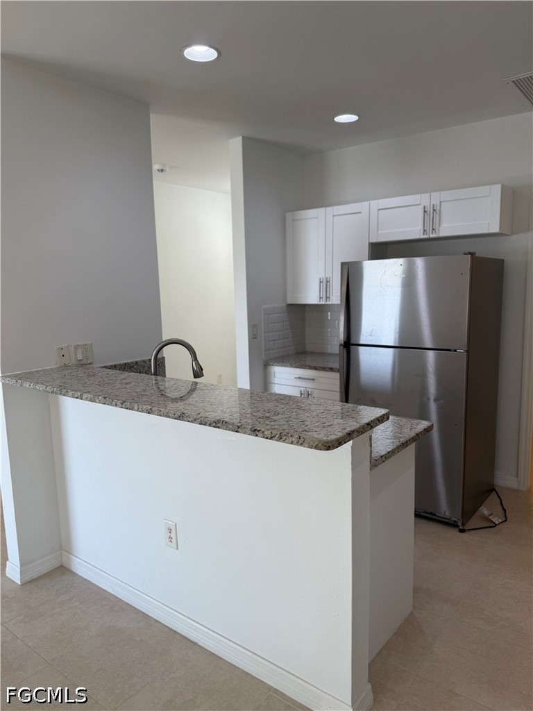 2916 7th Street Southwest Lehigh Acres, FL 33976 - Photo 9 of 19 a kitchen with stainless steel appliances granite countertop a refrigerator a sink and a stove