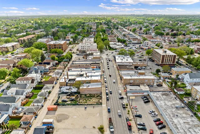an aerial view of residential houses with city view