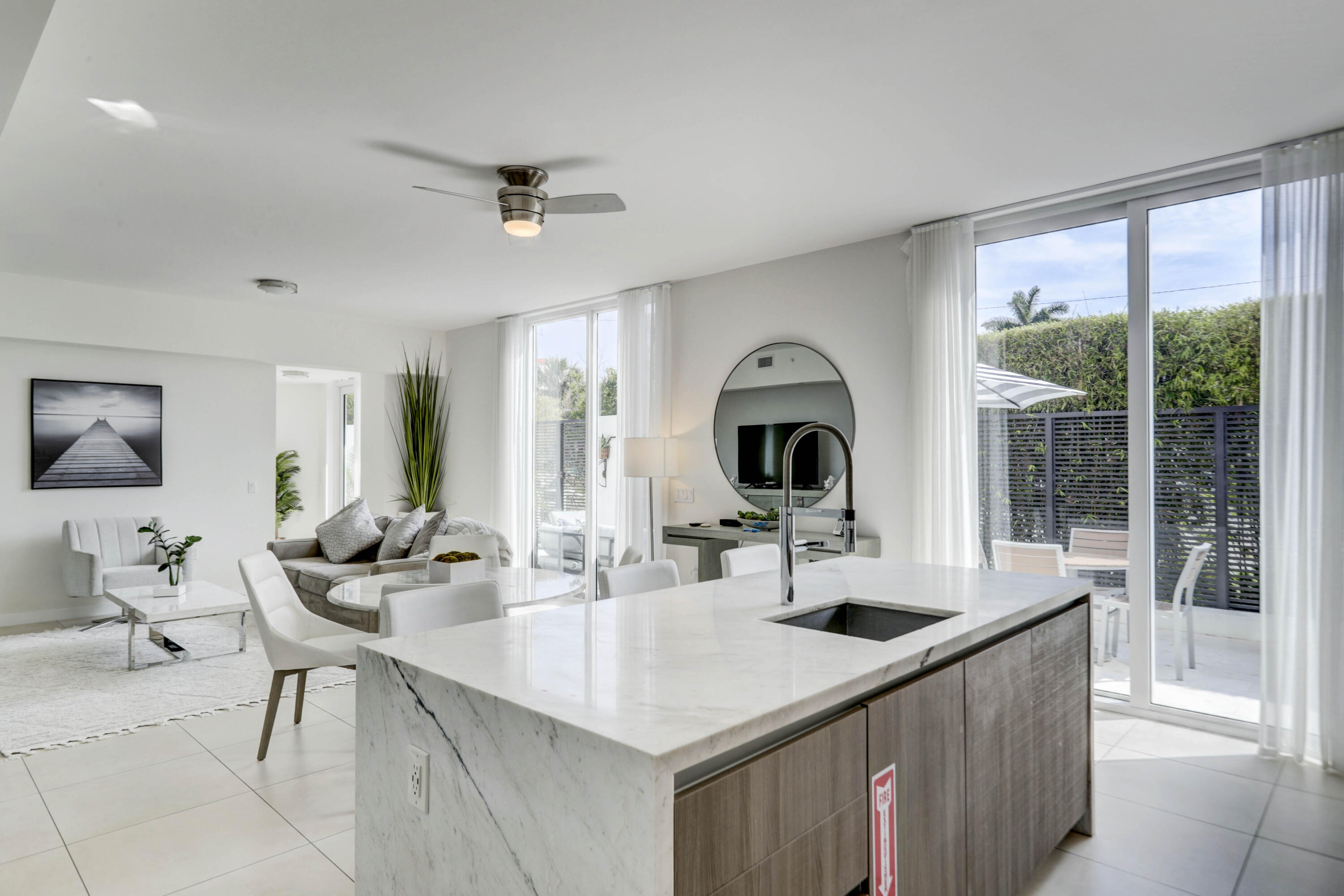 401 North Birch Road, Unit TH3 Fort Lauderdale, FL 33304 - Photo 15 of 49 a kitchen with a sink a counter and chairs