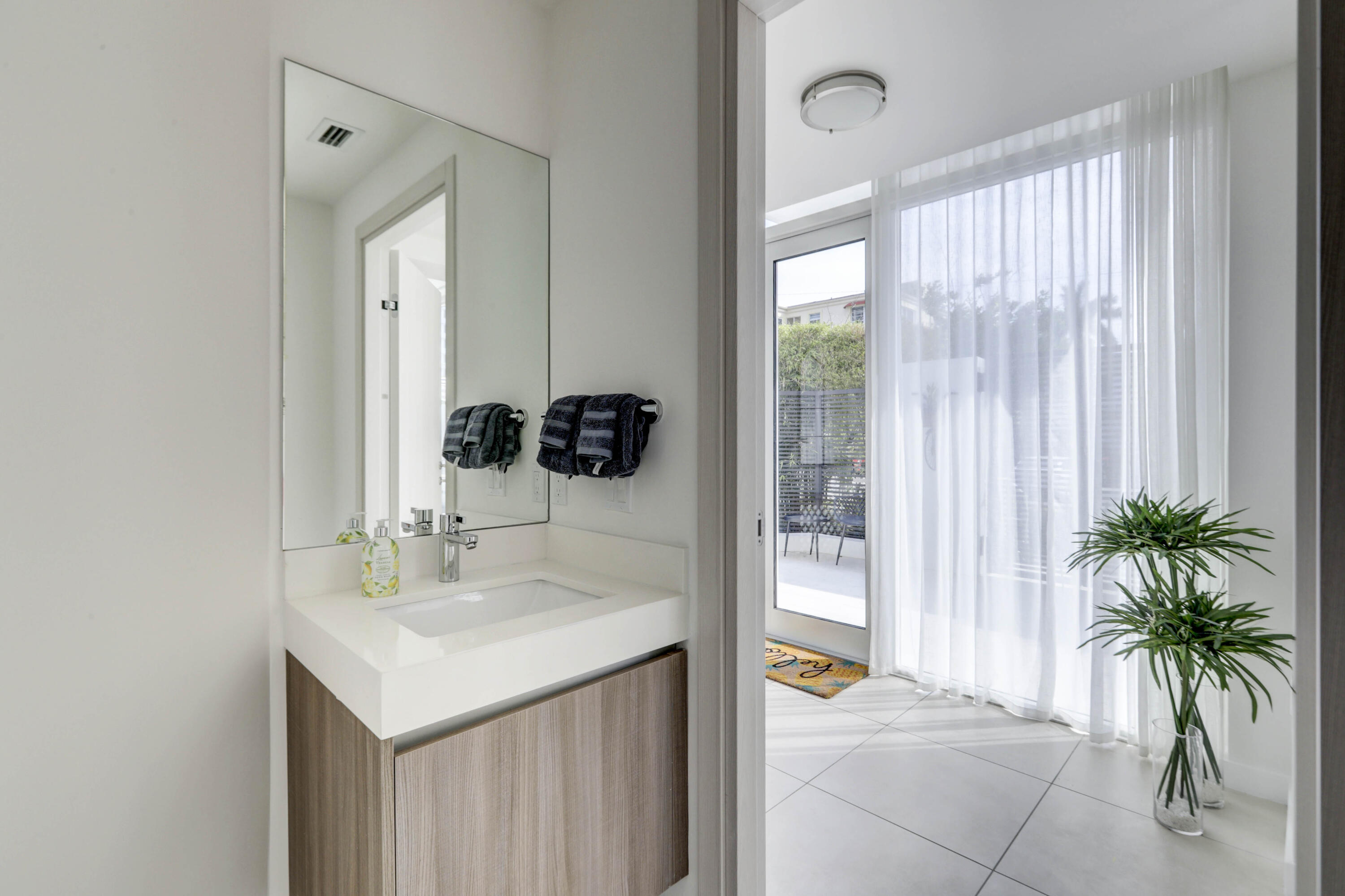 401 North Birch Road, Unit TH3 Fort Lauderdale, FL 33304 - Photo 17 of 49 a bathroom with a sink a mirror and a shower curtain