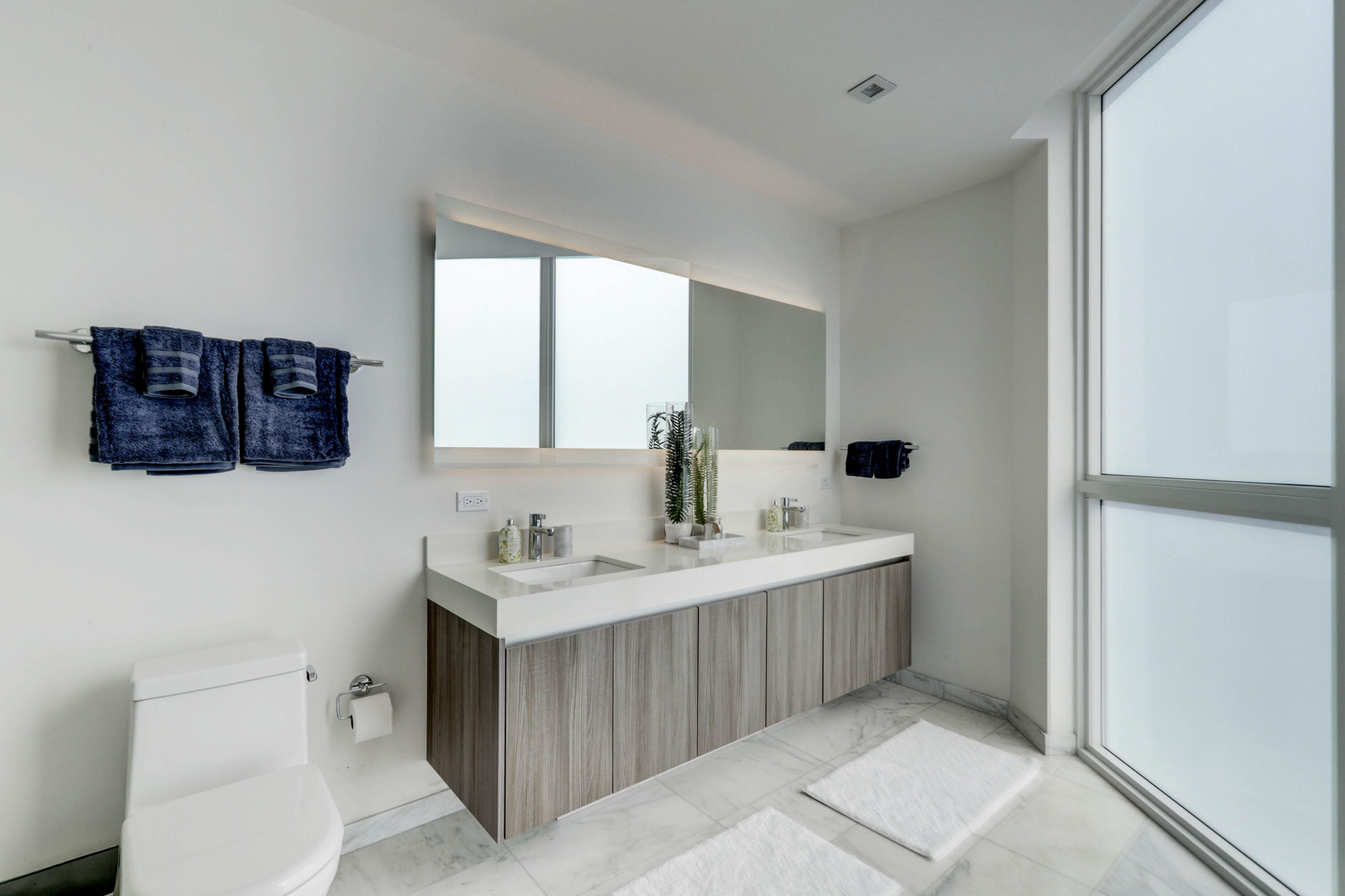 401 North Birch Road, Unit TH3 Fort Lauderdale, FL 33304 - Photo 23 of 49 a bathroom with a sink a toilet and mirror