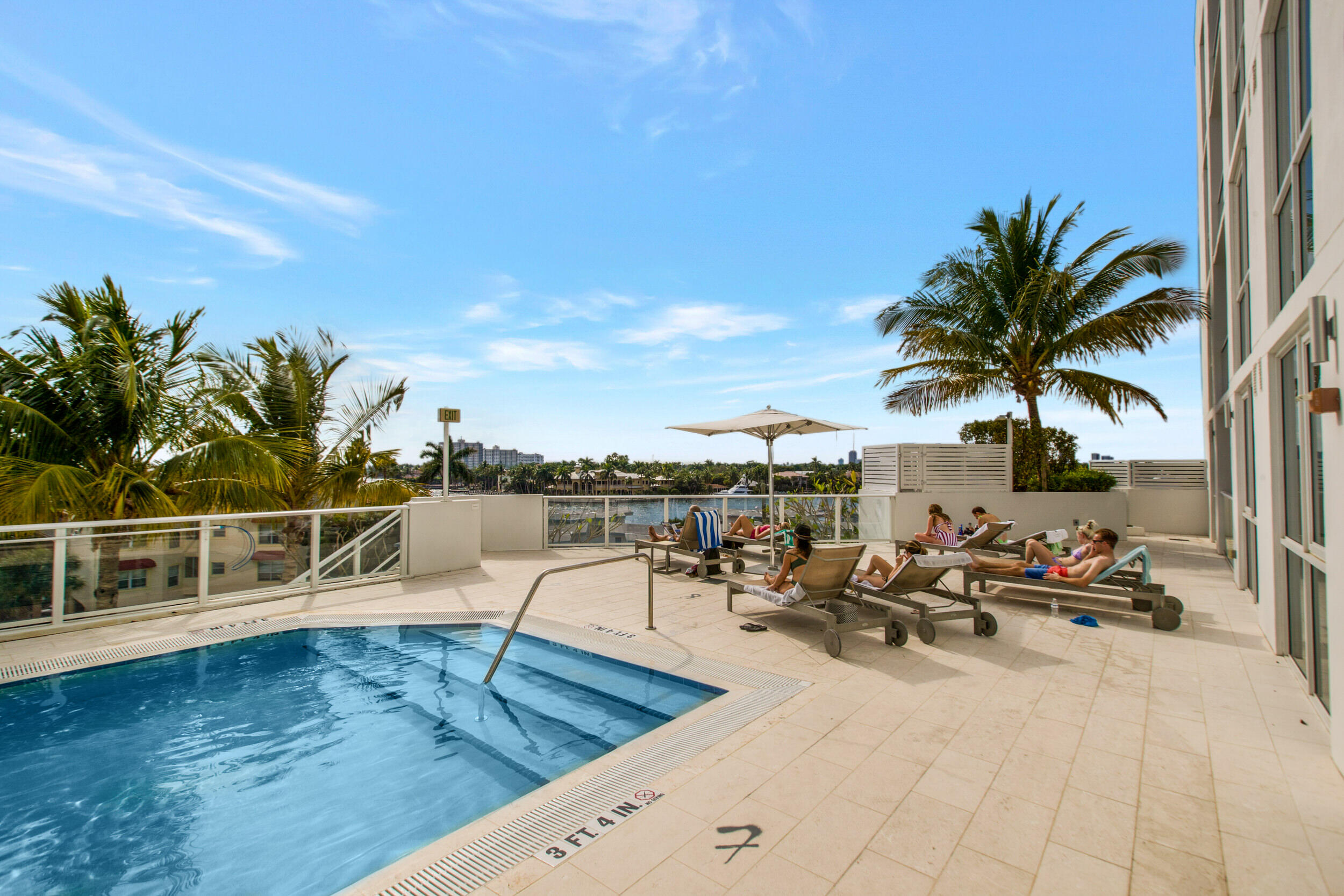 401 North Birch Road, Unit TH3 Fort Lauderdale, FL 33304 - Photo 37 of 49 a view of a swimming pool with a lounge chair and potted plants