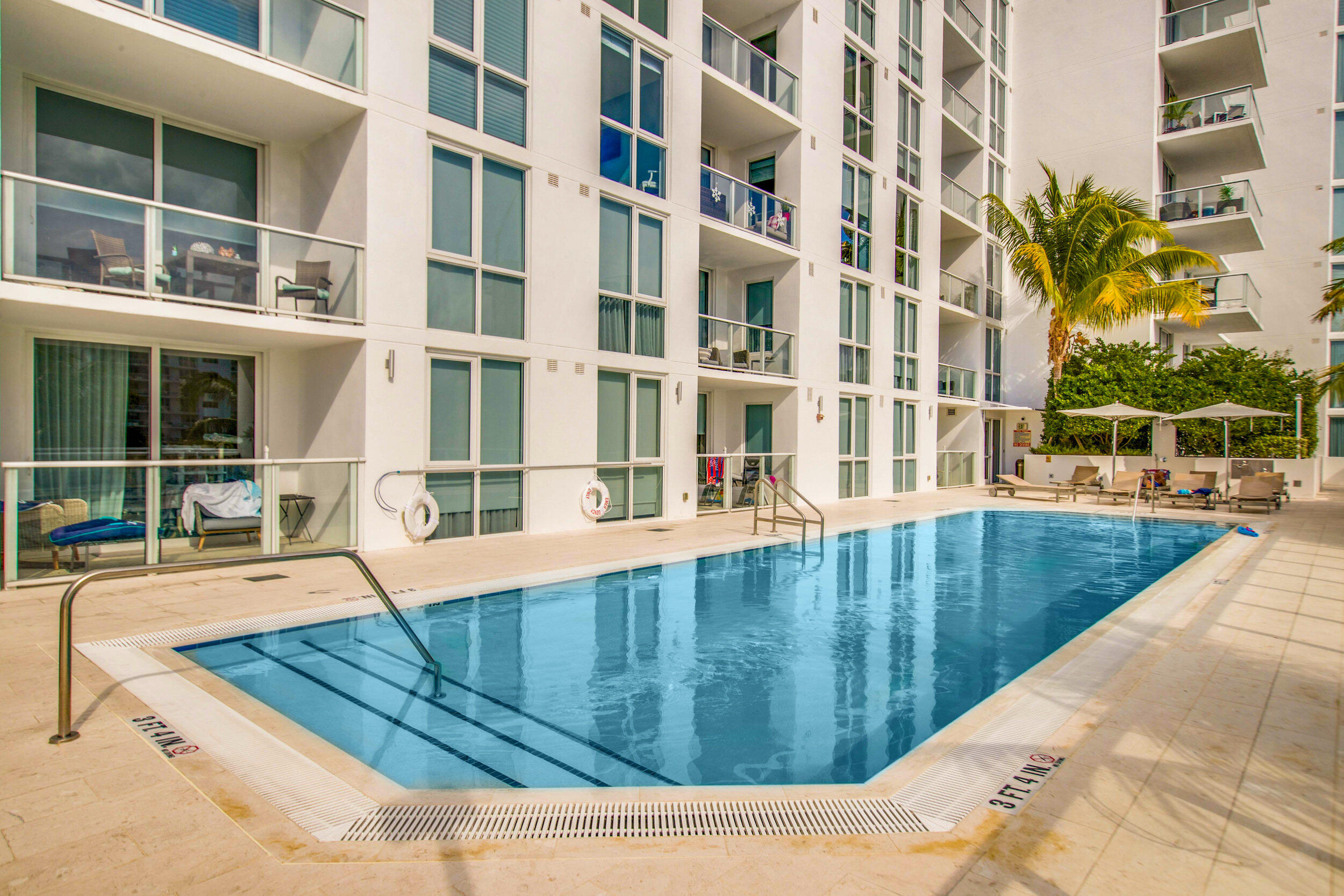 401 North Birch Road, Unit TH3 Fort Lauderdale, FL 33304 - Photo 39 of 49 a view of a swimming pool with a lounge chairs