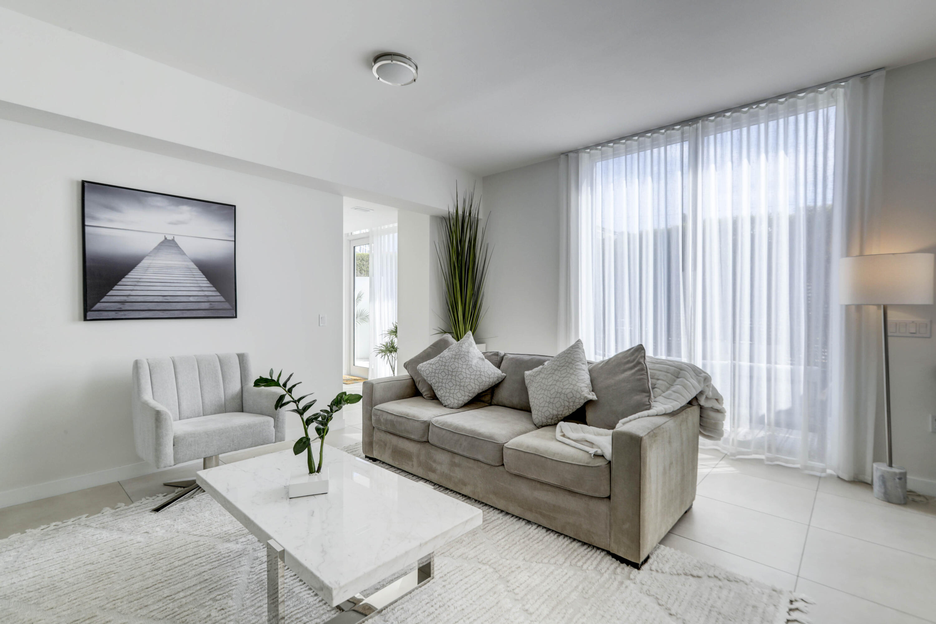 401 North Birch Road, Unit TH3 Fort Lauderdale, FL 33304 - Photo 8 of 49 a living room with furniture and a large window