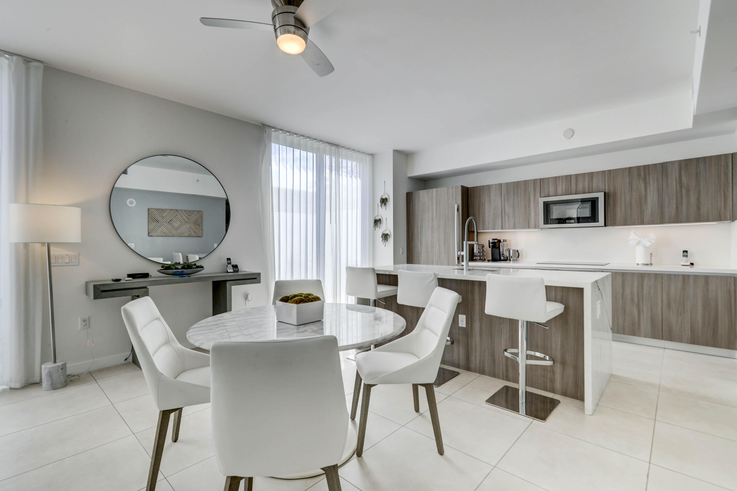 401 North Birch Road, Unit TH3 Fort Lauderdale, FL 33304 - Photo 9 of 49 a dining room with furniture and a mirror