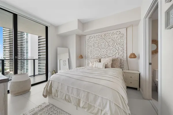 a bedroom with a large bed and a window