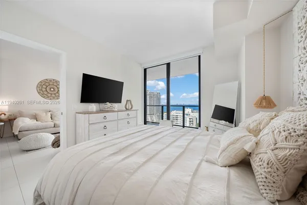 a bedroom with a bed and a flat screen tv