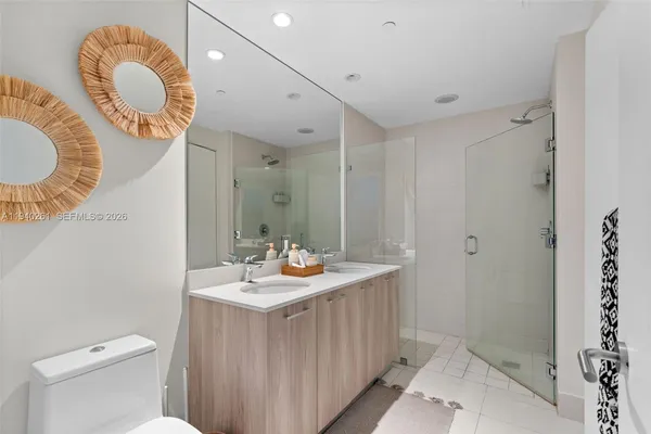 a bathroom with a sink mirror vanity and toilet