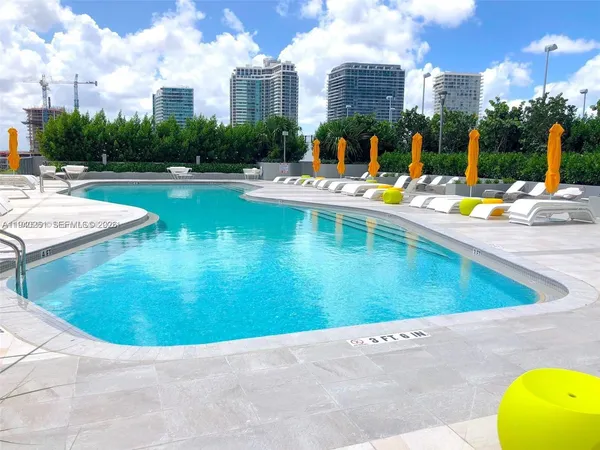 a view of a swimming pool with outdoor seating