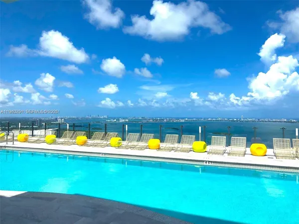 a swimming pool with outdoor seating