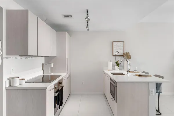 a kitchen with a sink cabinets and window