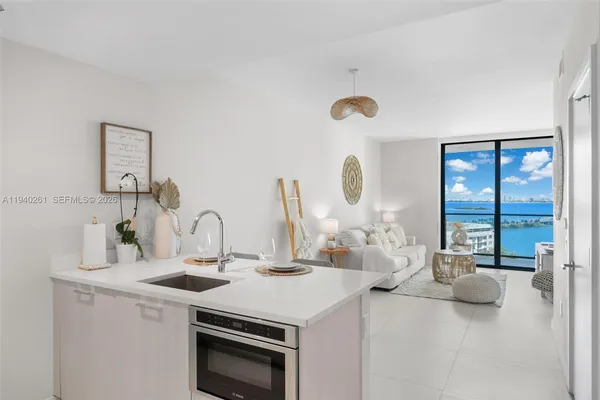 a kitchen with a sink a stove and cabinets