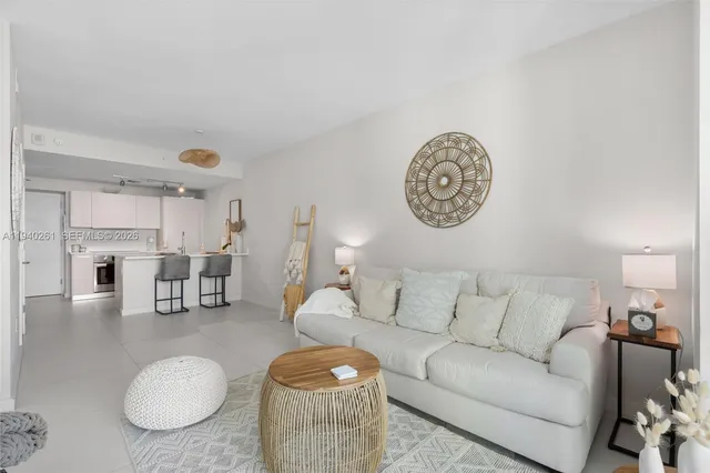 a living room with furniture a table and chairs