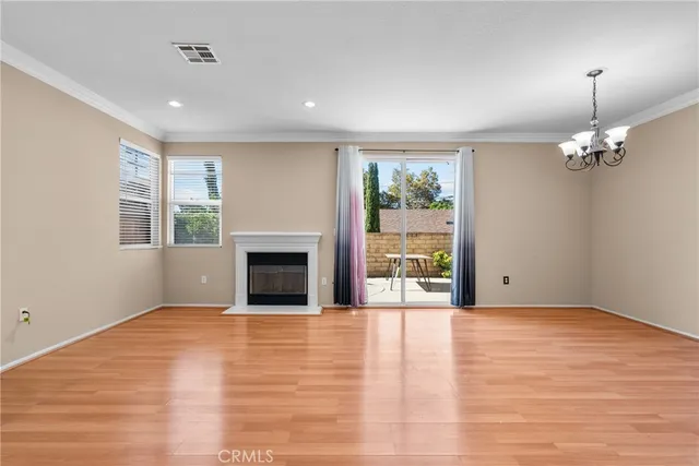 a view of empty room with wooden floor and fireplace