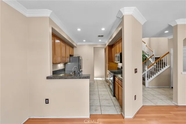 a kitchen with stainless steel appliances granite countertop a sink stove and refrigerator