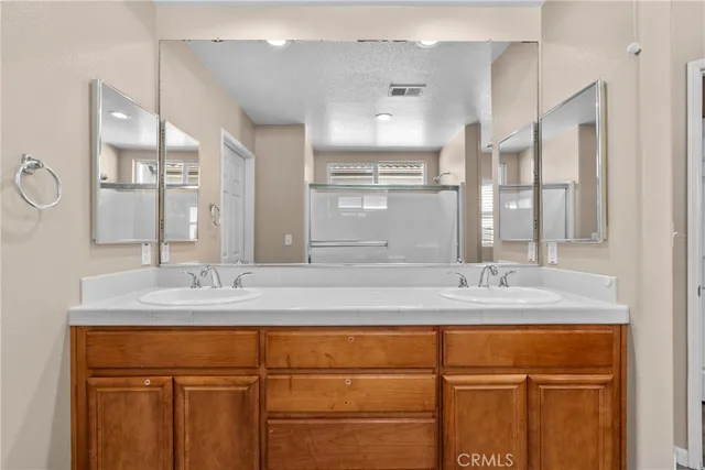 a spacious bathroom with a granite countertop sink mirror and a bathtub