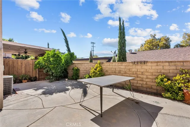 a view of a chair and table in the garden