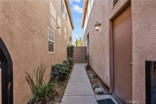 a view of a hallway with potted plants
