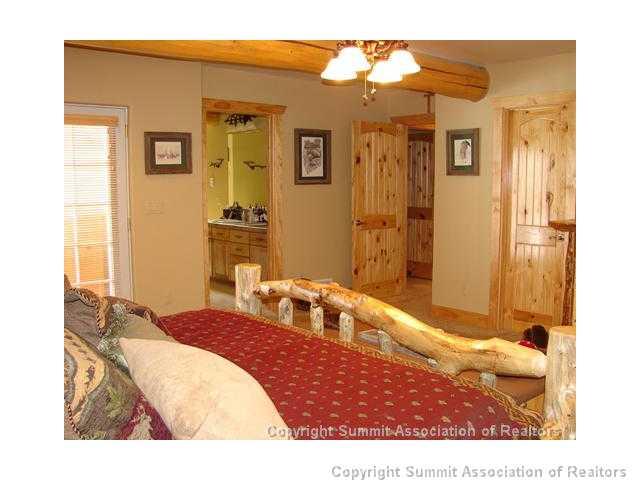 289 Round Hill Road Fairplay, CO 80440 - Photo 6 of 15 a bedroom with a bed and a mirror