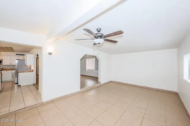 a view of a livingroom with a ceiling fan furniture and a ceiling fan