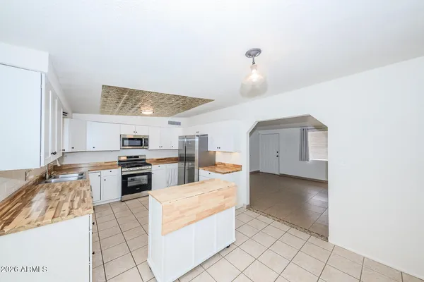 a large kitchen with cabinets and stainless steel appliances