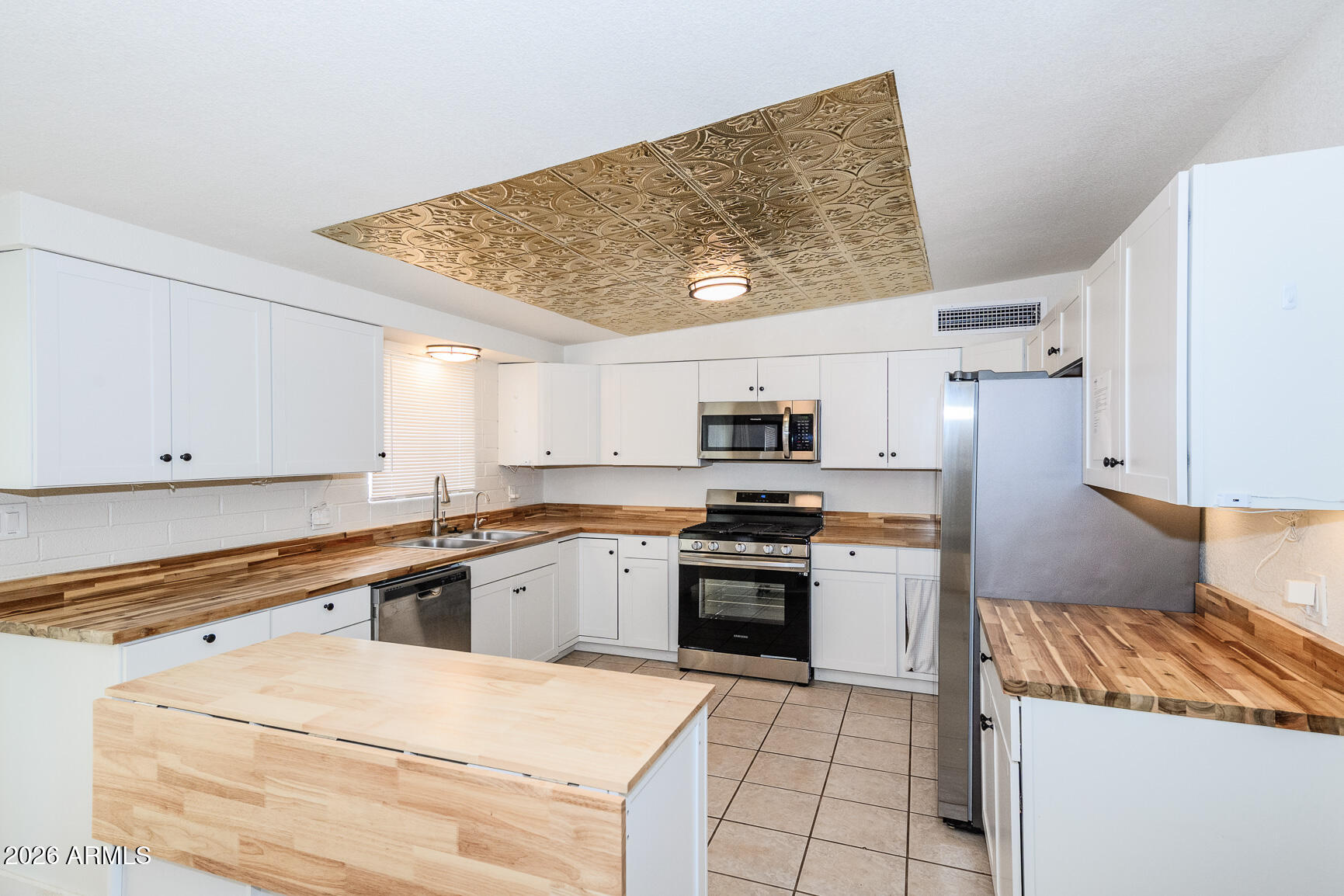 310 2nd Street Huachuca City, AZ 85616 - Photo 15 of 43 a kitchen with stainless steel appliances granite countertop a sink and white cabinets
