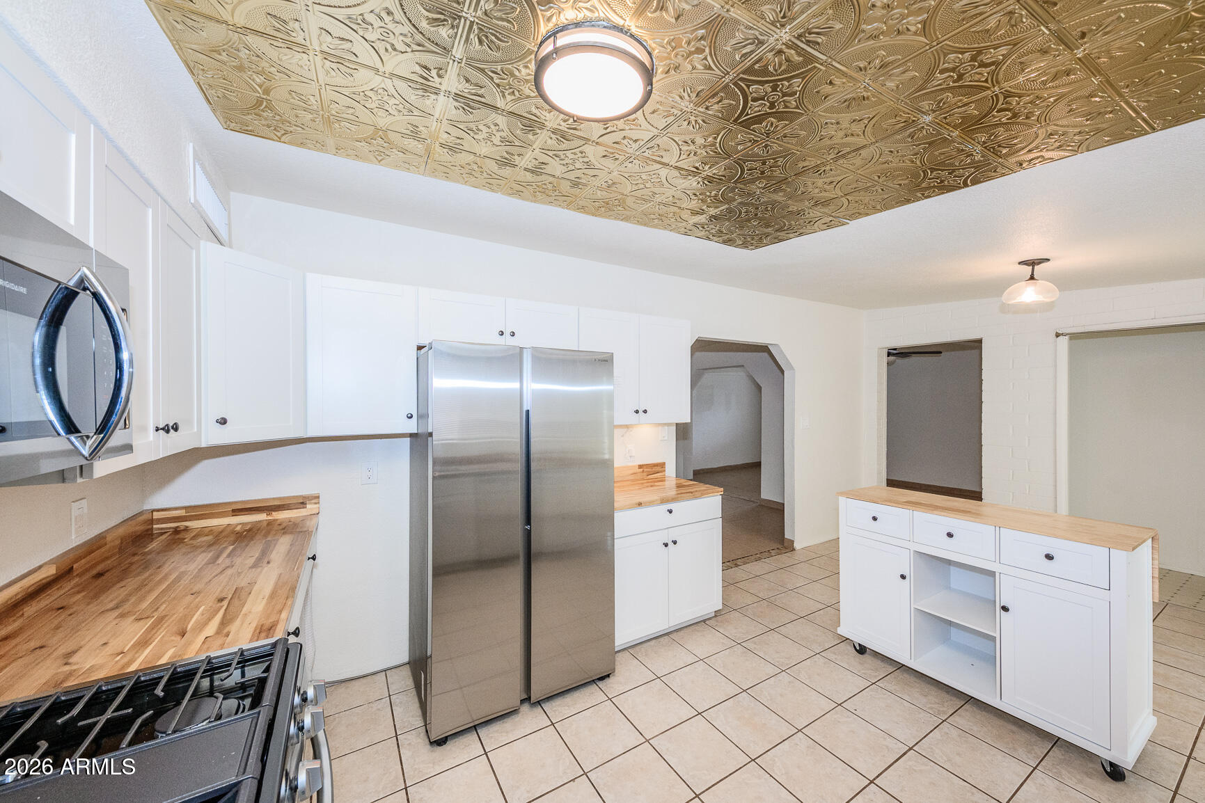310 2nd Street Huachuca City, AZ 85616 - Photo 17 of 43 a kitchen with granite countertop a stove a sink and a refrigerator