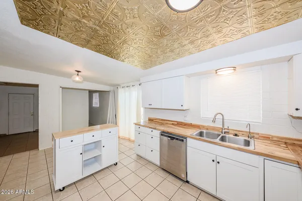 a room with white cabinets and sink