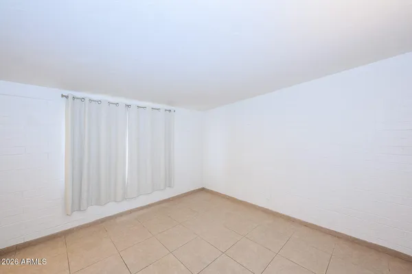 a view of an empty room and a window