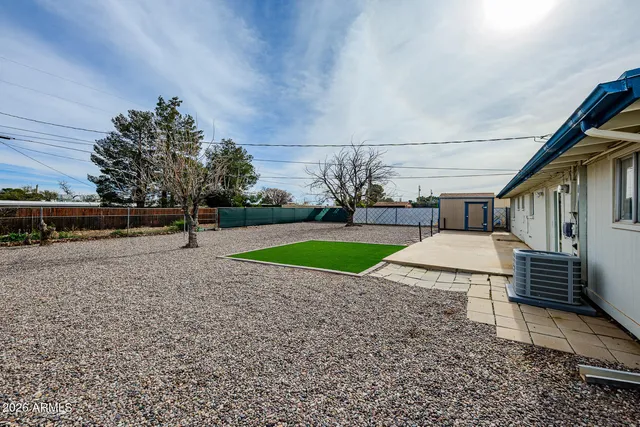 a view of a house with wooden fence