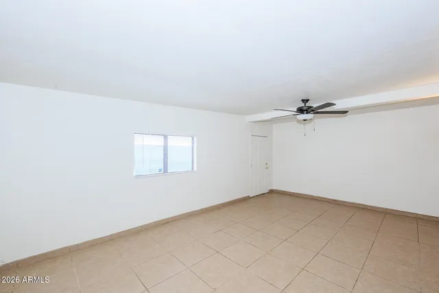 an empty room with a empty space and a ceiling fan