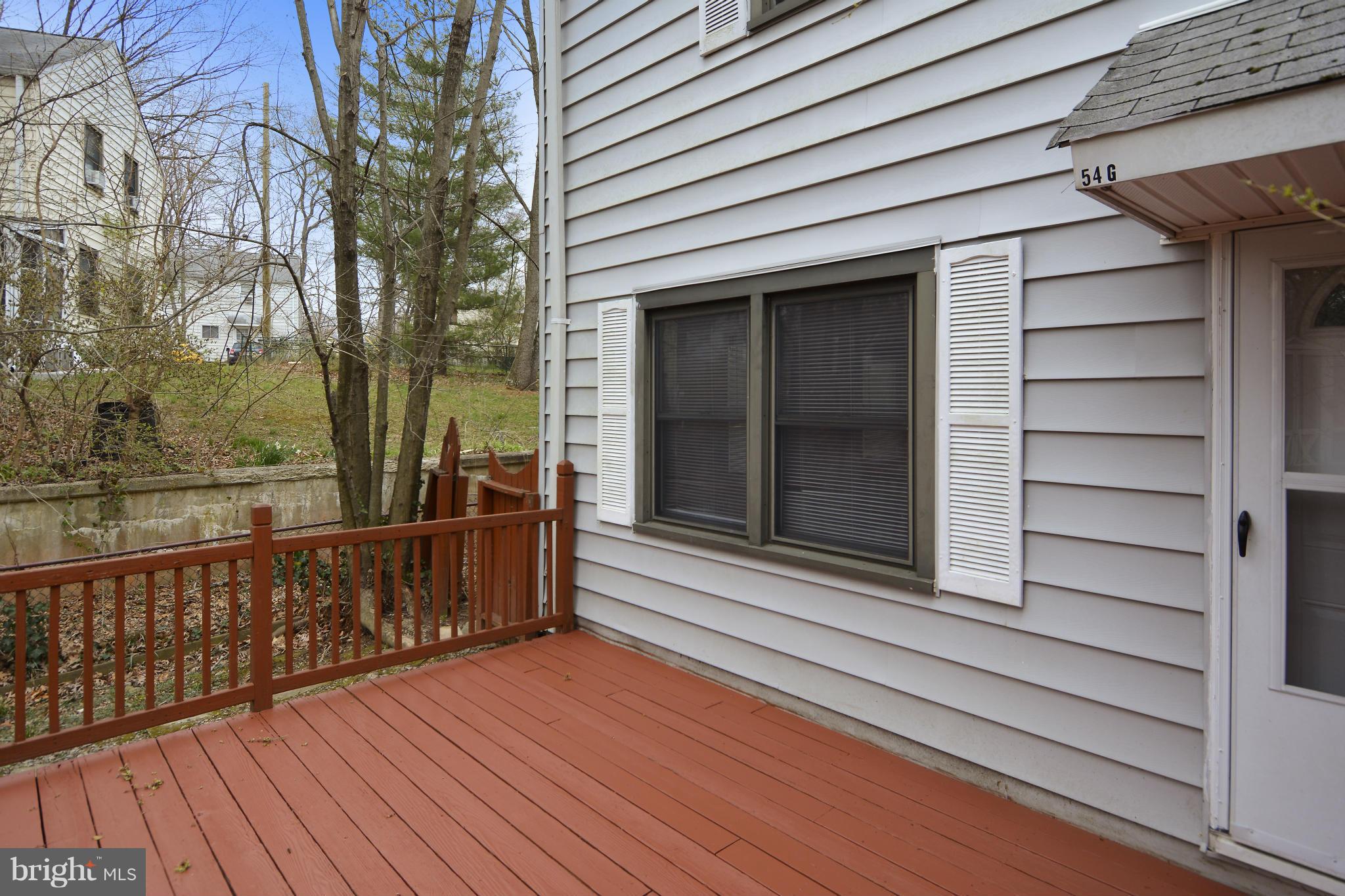 54 Ridge Road, Unit G Greenbelt, MD 20770 - Photo 21 of 30 a view of a balcony with wooden floor and fence