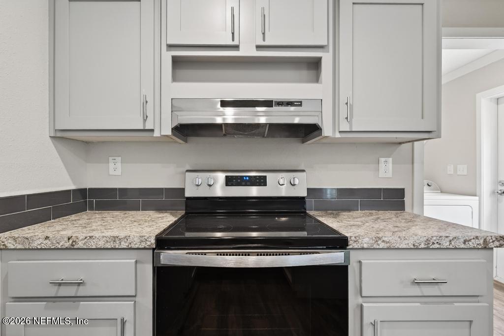 95605 Springhill Road Fernandina Beach, FL 32034 - Photo 13 of 62 a stove top oven sitting inside of a kitchen