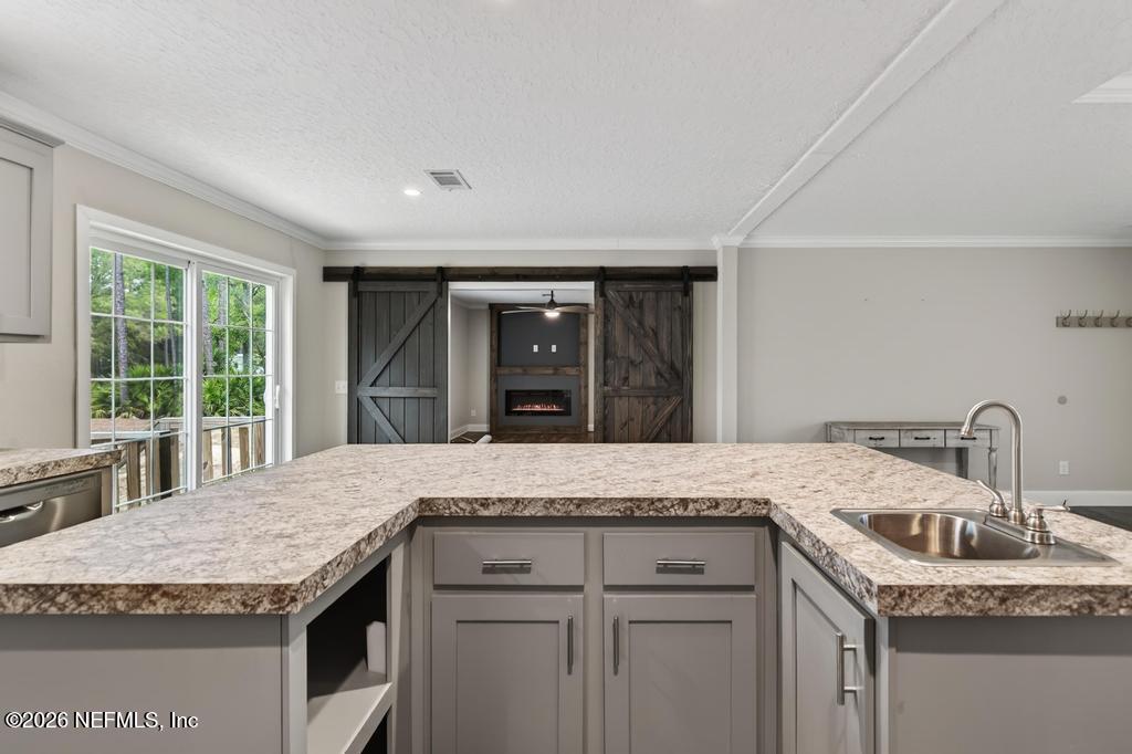 95605 Springhill Road Fernandina Beach, FL 32034 - Photo 14 of 62 a kitchen with granite countertop a sink and a window