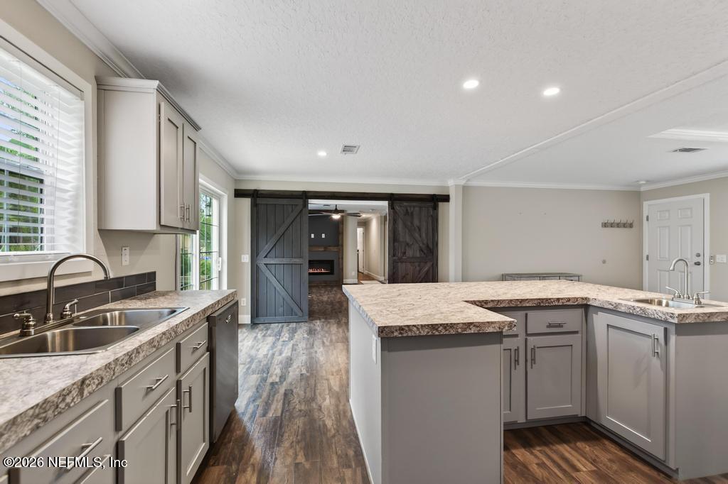 95605 Springhill Road Fernandina Beach, FL 32034 - Photo 15 of 62 a kitchen with granite countertop a sink stove and cabinets
