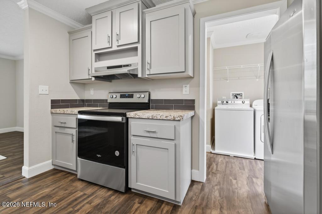 95605 Springhill Road Fernandina Beach, FL 32034 - Photo 18 of 62 a kitchen with stainless steel appliances white cabinets and sink