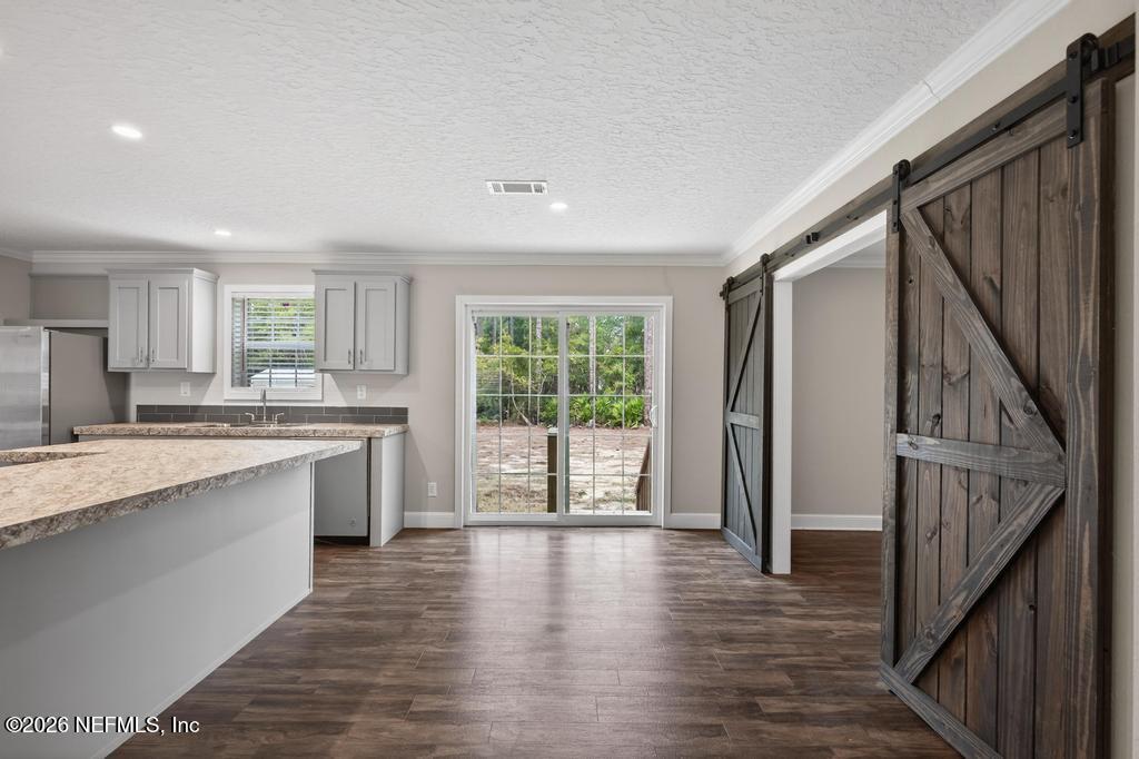 95605 Springhill Road Fernandina Beach, FL 32034 - Photo 21 of 62 a large kitchen with a window and wooden floor